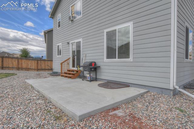 6218 Pilgrimage Road Colorado Springs, CO 80925 - Photo 42 of 42 Exterior Concrete patio and home has all window wells