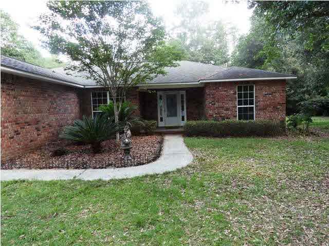 5524 Fox Fire Road Milton, FL 32570 - Photo 2 of 25 1.25 ACRES OF LARGE TREES, BLOOMING PLANTS AND FLOWERS