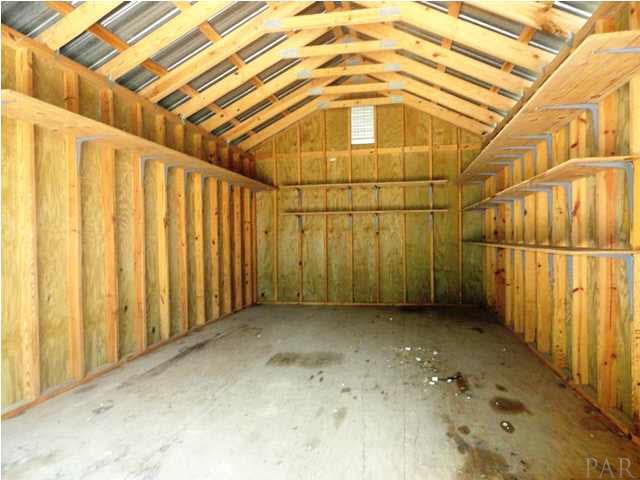 5524 Fox Fire Road Milton, FL 32570 - Photo 21 of 25 INSIDE WORKSHOP WITH SHELVES