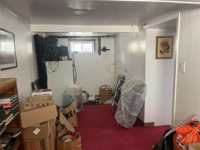 a view of a hallway with wooden floor and entryway