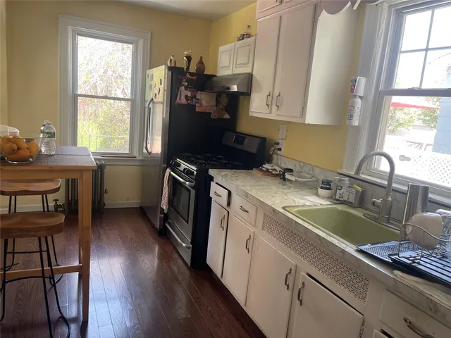 a kitchen with a sink stove and cabinets