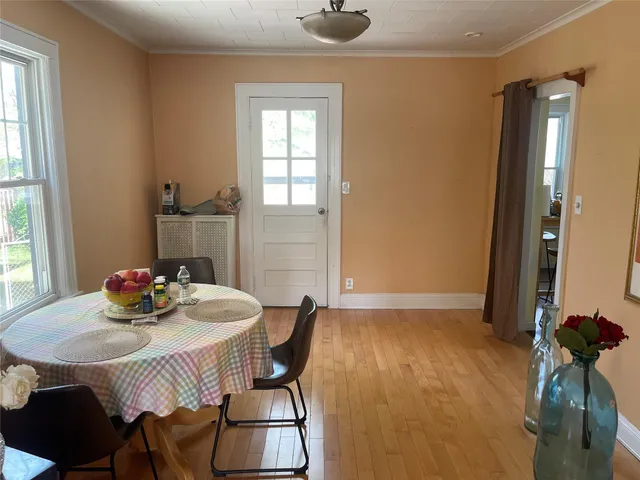 a view of a dining room with furniture and window