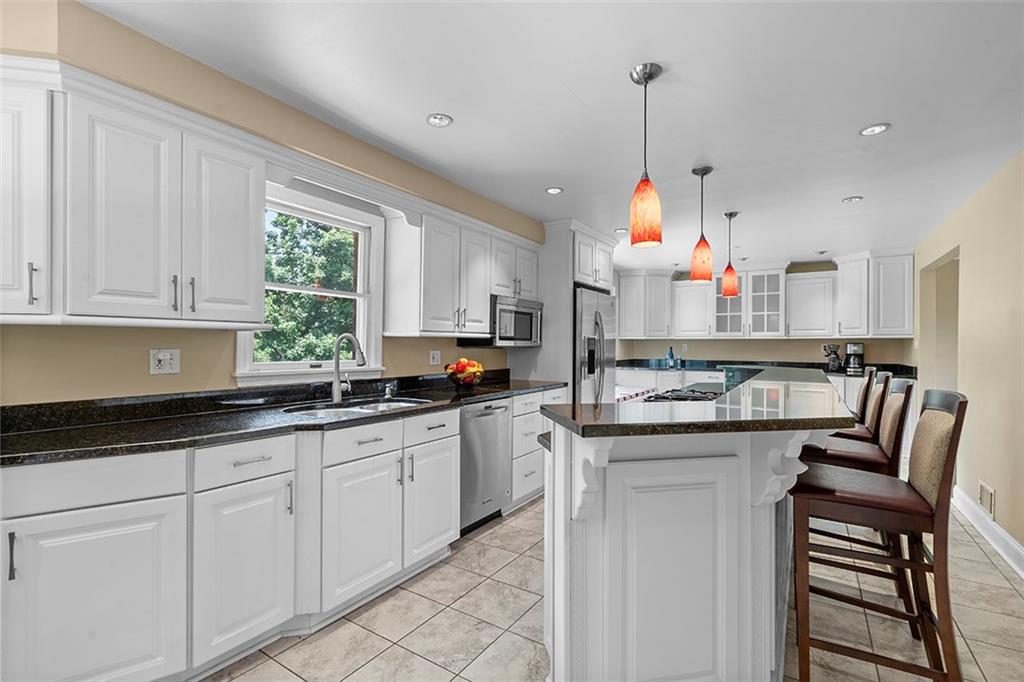 533 Woodland Road Pittsburgh, PA 15237 - Photo 12 of 43 a kitchen with white cabinets and sink