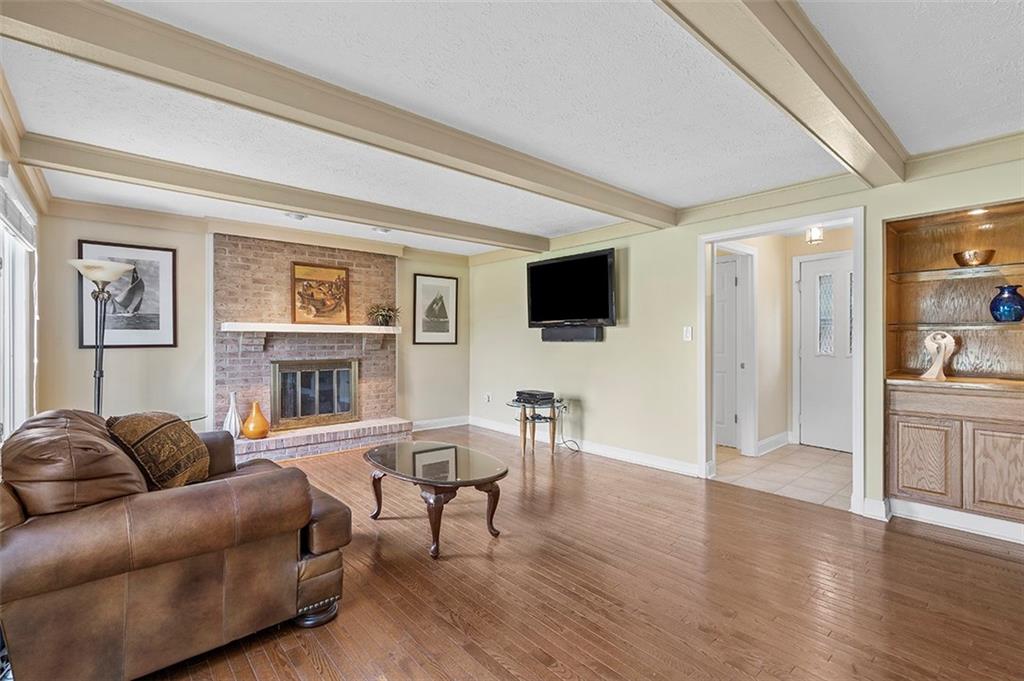533 Woodland Road Pittsburgh, PA 15237 - Photo 16 of 43 a living room with furniture a fireplace and a flat screen tv