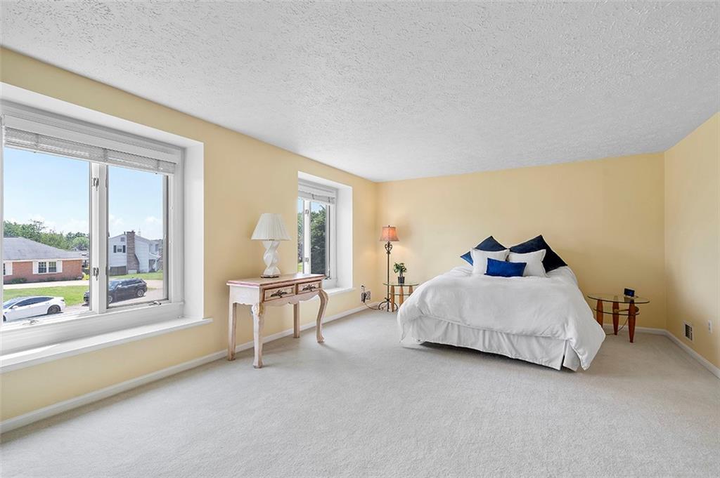 533 Woodland Road Pittsburgh, PA 15237 - Photo 22 of 43 a spacious bedroom with a bed and large window