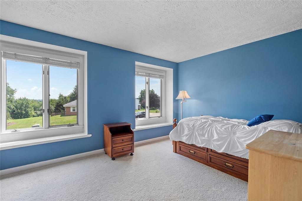 533 Woodland Road Pittsburgh, PA 15237 - Photo 29 of 43 a bed sitting in a bedroom next to a window