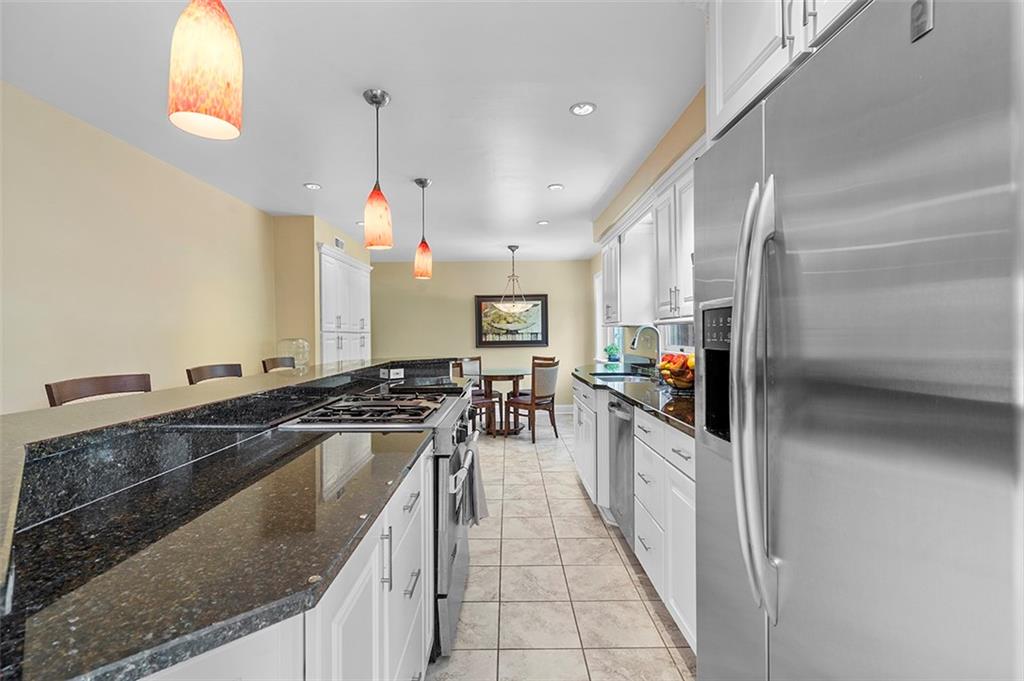 533 Woodland Road Pittsburgh, PA 15237 - Photo 9 of 43 a kitchen with granite countertop a stove and a sink