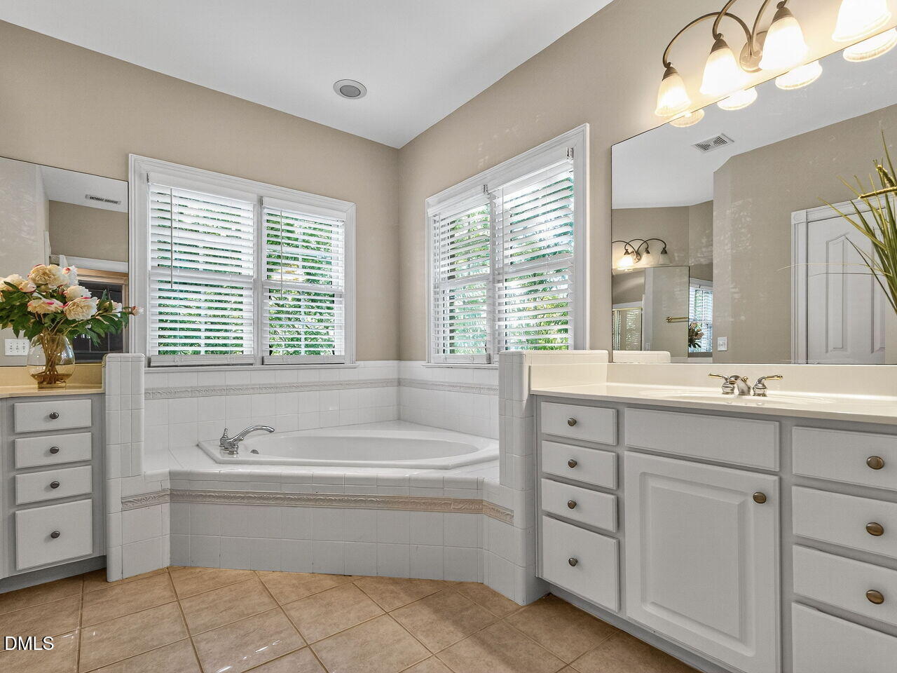 3900 Bentley Bridge Road Raleigh, NC 27612 - Photo 17 of 27 a spacious bathroom with double vanity sink a two mirror a bathtub a vanity and a bathtub