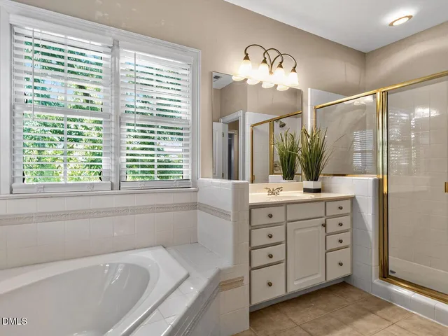 a bathroom with a large tub sink and double vanity