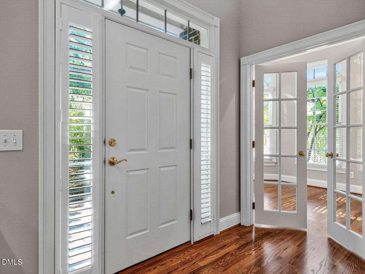3900 Bentley Bridge Road Raleigh, NC 27612 - Photo 2 of 27 a view of an empty room with wooden floor and a window
