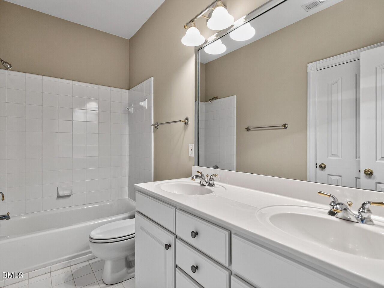 3900 Bentley Bridge Road Raleigh, NC 27612 - Photo 21 of 27 a bathroom with a double vanity sink a toilet and shower