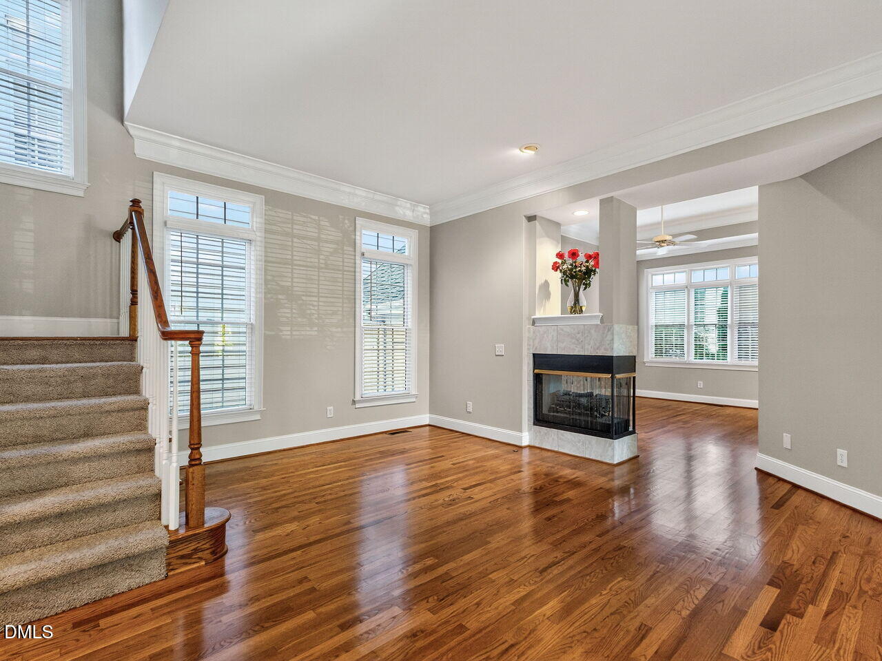 3900 Bentley Bridge Road Raleigh, NC 27612 - Photo 4 of 27 a view of an empty room with wooden floor fireplace and a window