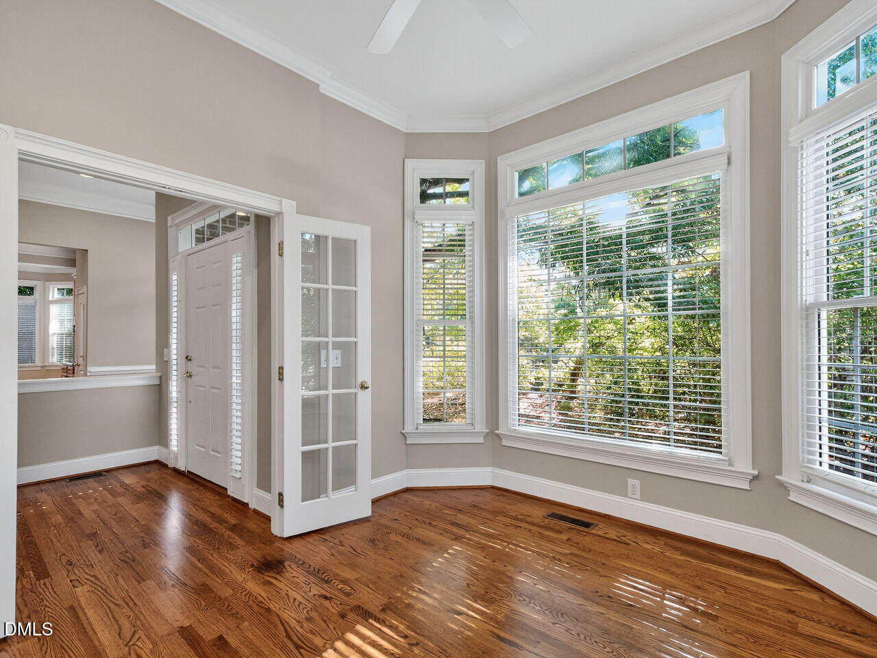 3900 Bentley Bridge Road Raleigh, NC 27612 - Photo 7 of 27 a view of an empty room with wooden floor and a window
