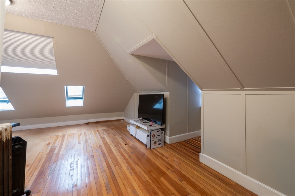 11 Wayne Street Boston, MA 02121 - Photo 27 of 27 a view of an empty room with wooden floor and a window