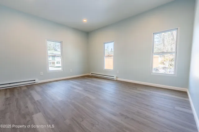 a spacious bathroom with a double vanity sink a toilet and a shower
