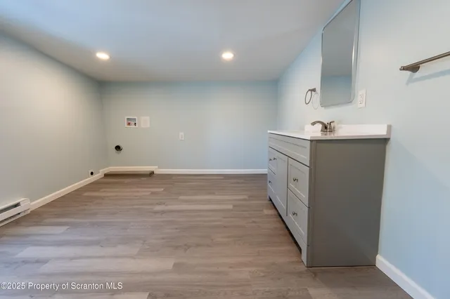 a kitchen with a stove and white cabinets