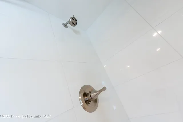 a kitchen with white cabinets and a microwave oven