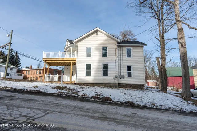 a view of a kitchen with kitchen island wooden floor center island and stainless steel appliances