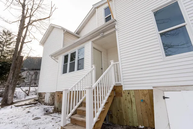 a bathroom with a sink toilet and a window