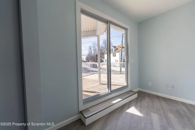 a view of a balcony with wooden floor