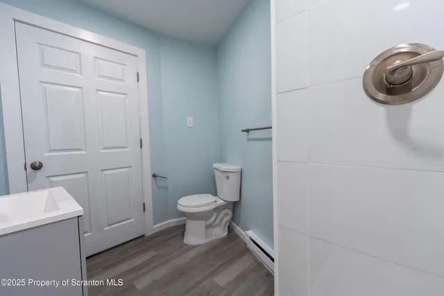 a view of an empty room and wooden floor