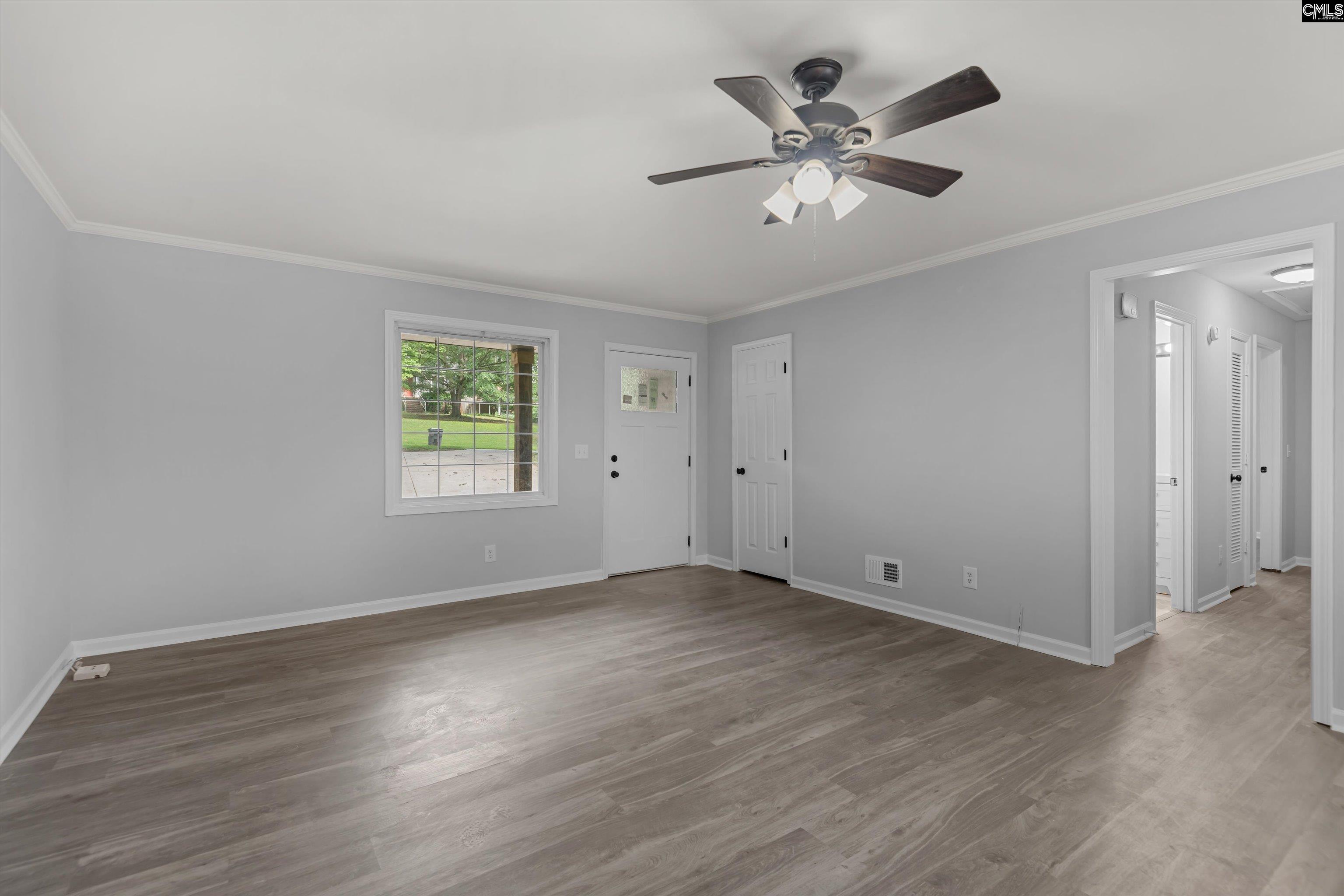 245 Piney Grove Road Columbia, SC 29210 - Photo 4 of 29 a view of an empty room with wooden floor and a ceiling fan