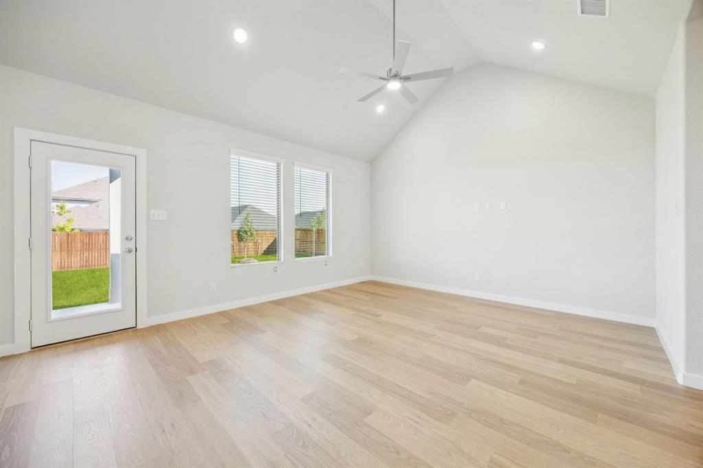9509 Rattlesnake Trail Crowley, TX 76036 - Photo 14 of 35 an empty room with wooden floor and windows
