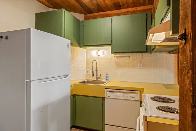 a white refrigerator freezer sitting inside of a kitchen