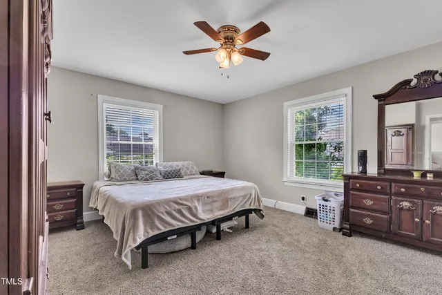 a bedroom with a bed dresser and a window