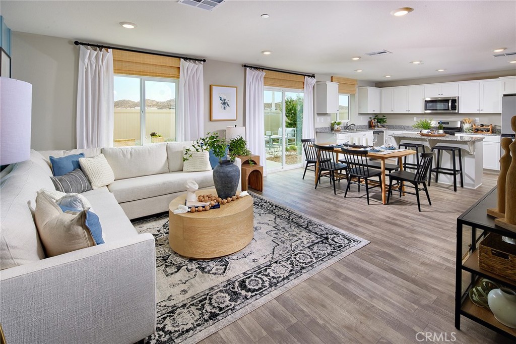 30607 Cyclone Avenue Winchester, CA 92596 - Photo 4 of 18 a living room kitchen with a dining table wooden floor and a large window