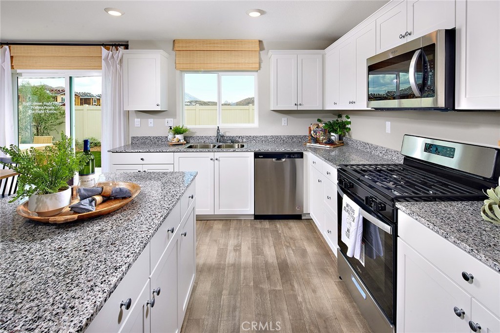 30607 Cyclone Avenue Winchester, CA 92596 - Photo 6 of 18 a kitchen with sink stove and microwave