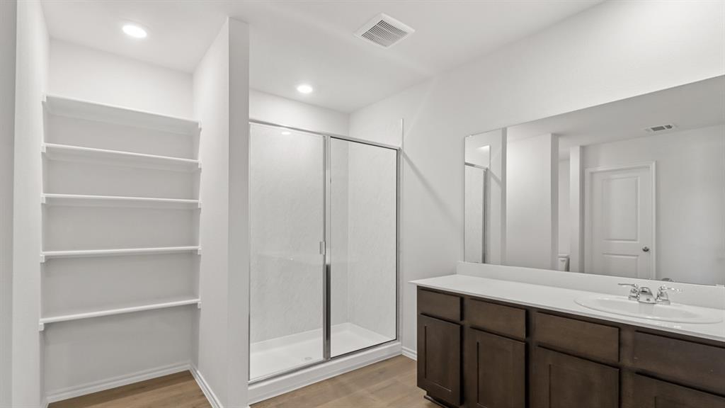 1913 Reveille Way Terrell, TX 75160 - Photo 11 of 27 Bathroom with a shower stall, light wood-style floors, and vanity