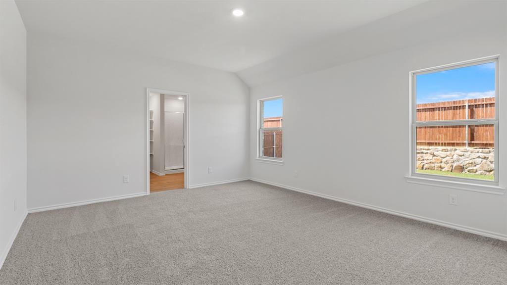 1913 Reveille Way Terrell, TX 75160 - Photo 12 of 27 Unfurnished bedroom with light colored carpet, lofted ceiling, and recessed lighting