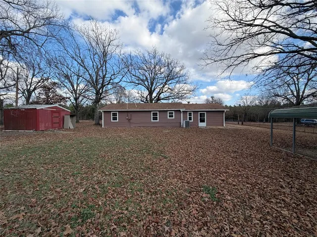 a front view of house with yard and trees