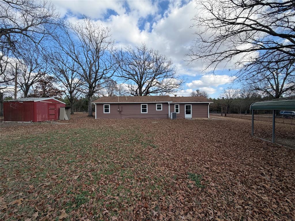 2293 County Road Powderly, TX 75473 - Photo 18 of 20 a front view of house with yard and trees
