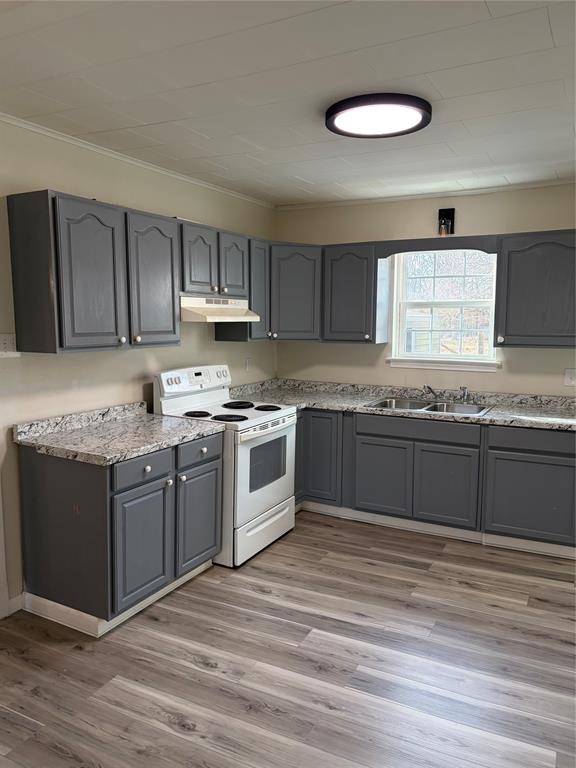 2293 County Road Powderly, TX 75473 - Photo 4 of 20 a kitchen with stainless steel appliances granite countertop a stove a sink and a microwave
