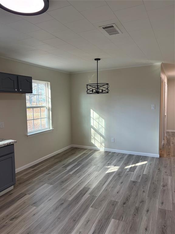 2293 County Road Powderly, TX 75473 - Photo 5 of 20 a view of an empty room with a window and wooden floor