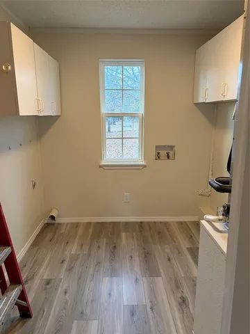 a view of a room with wooden floor and a window