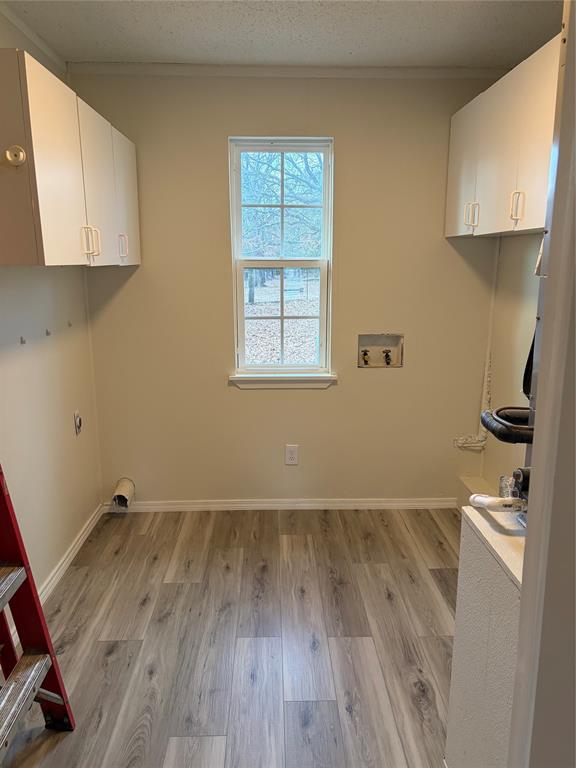 2293 County Road Powderly, TX 75473 - Photo 6 of 20 a view of a room with wooden floor and a window