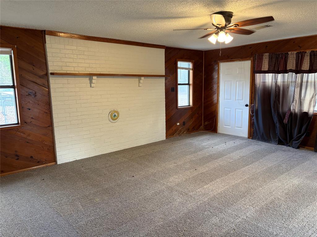 2293 County Road Powderly, TX 75473 - Photo 9 of 20 a view of a livingroom with a ceiling fan and a window