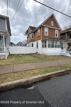 a view of a house next to a yard