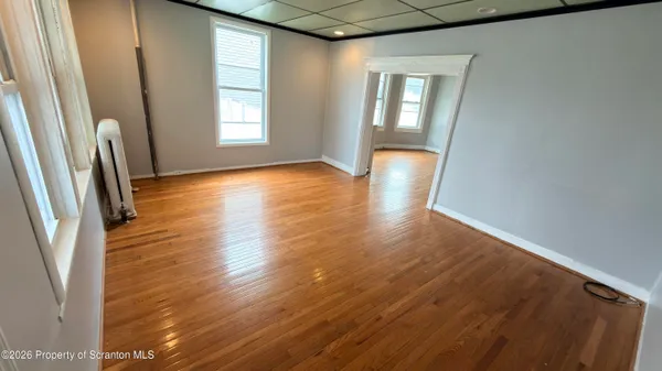 wooden floor in an empty room with a window