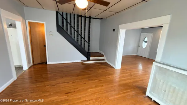 a view of a hallway view with wooden floor and staircase