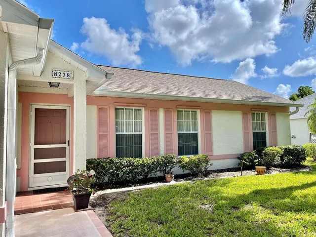 a front view of a house with a garden and patio