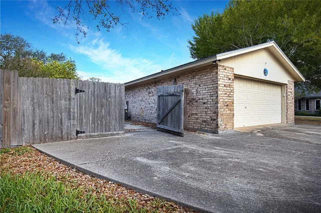 a view of a house with a backyard and garage