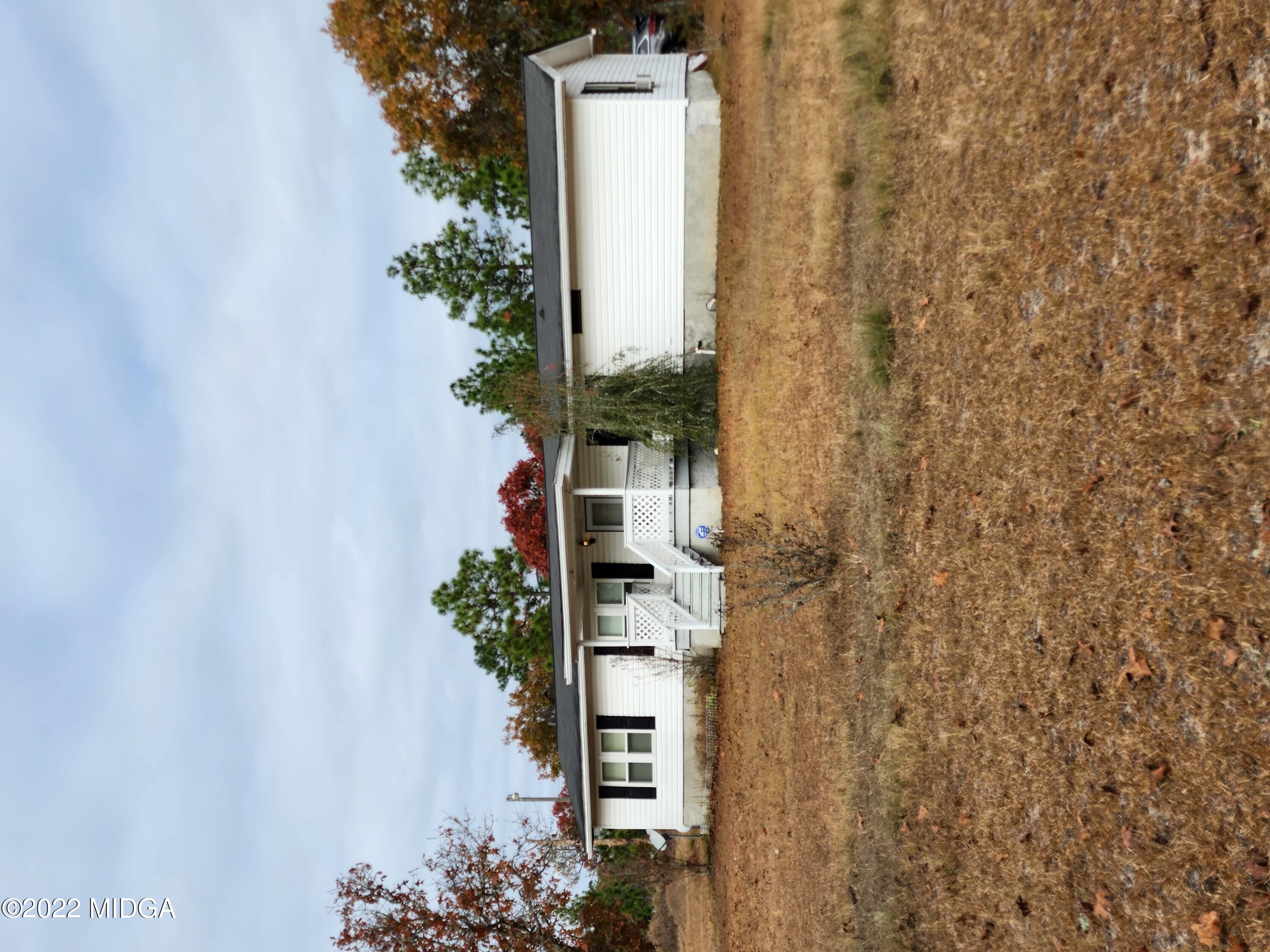 815 Pottery Road Lizella, GA 31052 - Photo 1 of 21 a front view of a house with a garden and yard