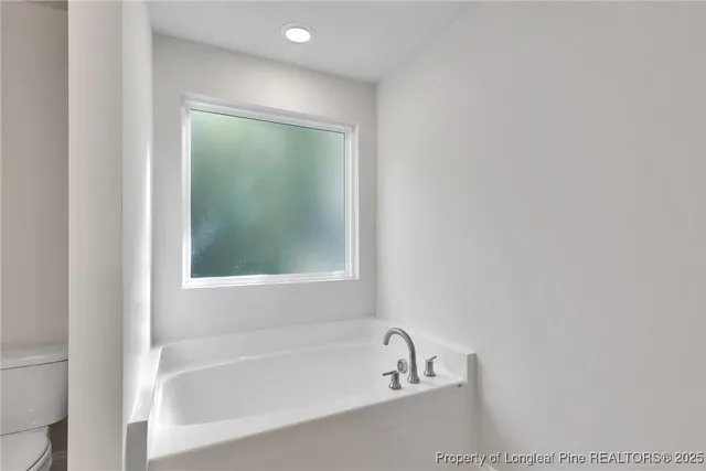 a white bath tub sitting next to a window