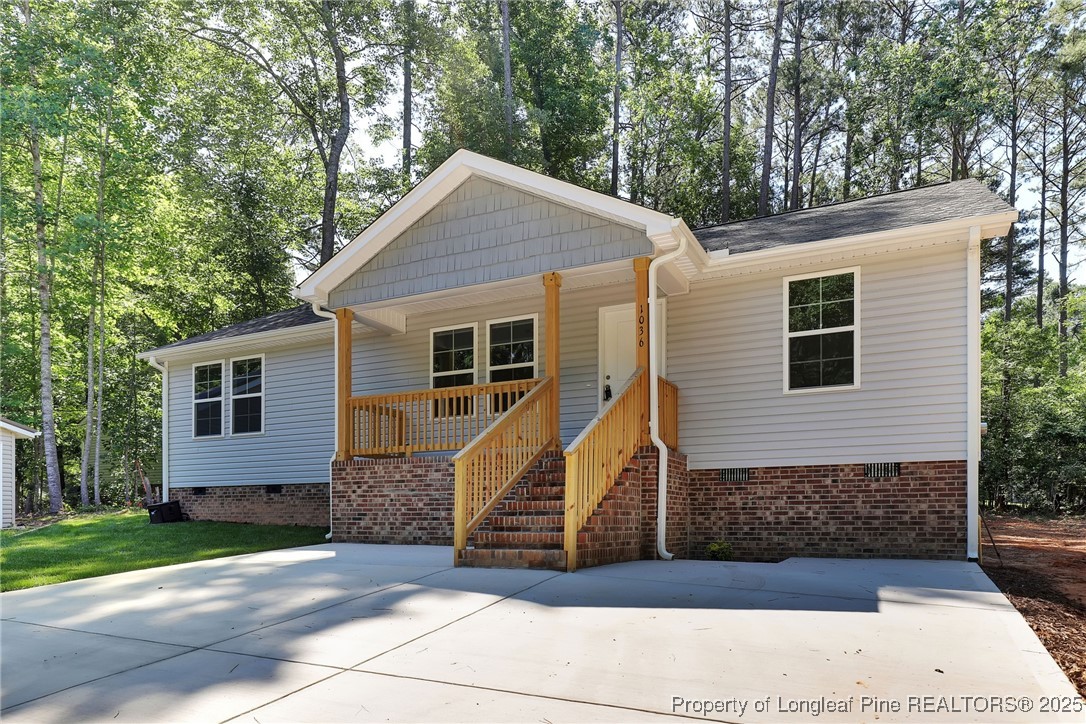 1036 Meadow Reach Sanford, NC 27332 - Photo 2 of 30 a view of a house with a yard