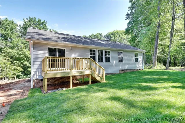 a view of a house with a yard and deck
