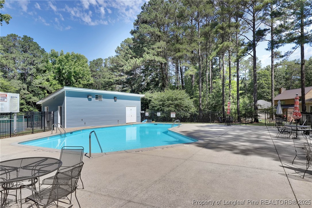 1036 Meadow Reach Sanford, NC 27332 - Photo 23 of 30 a patio with a table and chairs and potted plants